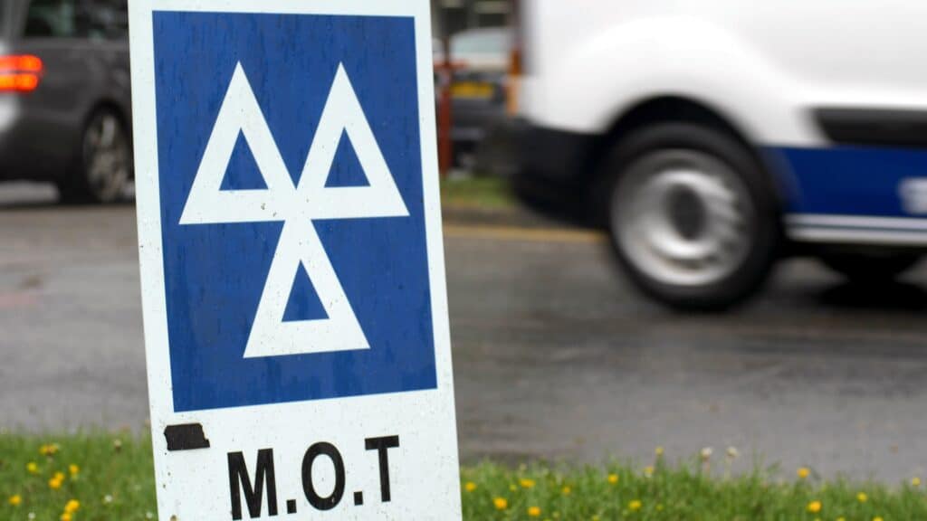 MOT testing station sign at car repair workshop for vehicle inspection and maintenance.