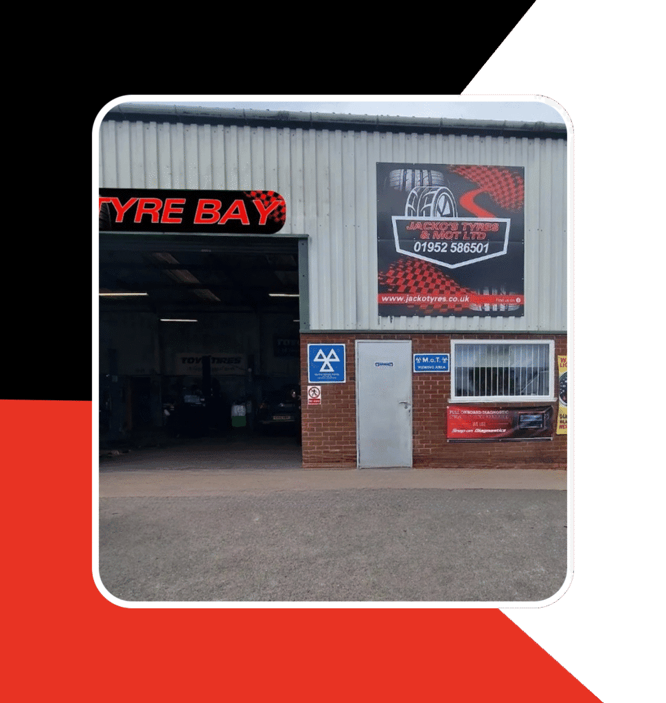 Front of our garage building with a black and red branded border reflecting our garage colours